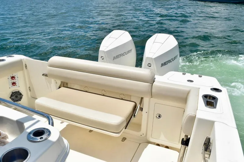 Slide: The Image of 2023 Boston Whaler 280 Outrage boat with dual Mercury engines on open water. - 9
