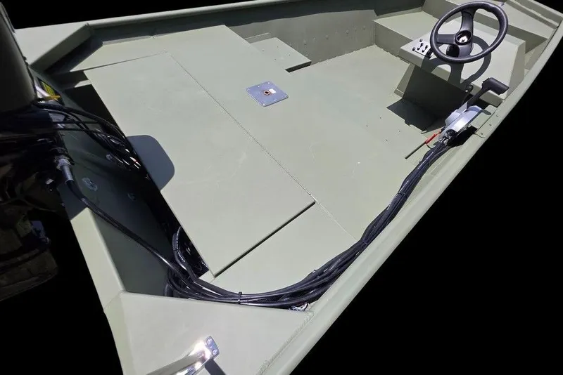 Slide: The Image of 2026 Weldcraft 1648 UV/DD ECONO Bass boat interior with steering wheel and control cables. - 10