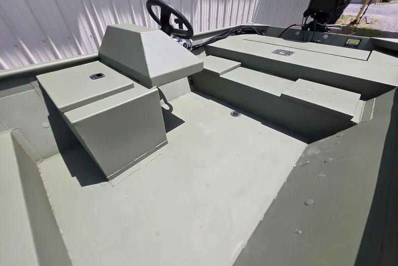 Slide: The Image of 2026 Weldcraft 1648 UV/DD ECONO Bass boat interior with steering wheel and storage compartments. - 24