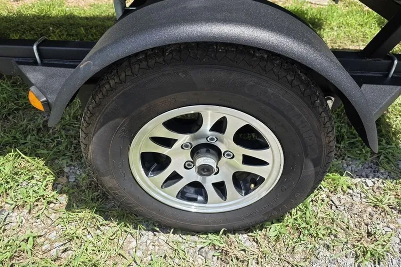 Slide: The Image of Trailer wheel of 2026 Weldcraft 1648 UV/DD ECONO Bass on grass and gravel. - 4