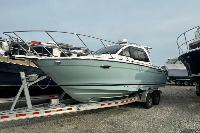 The Image of 2017 Cutwater C24 boat on trailer, parked in a marina lot. - 0