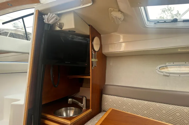 Slide: The Image of Interior of 2017 Cutwater C24 boat with TV, sink, and seating area. - 10