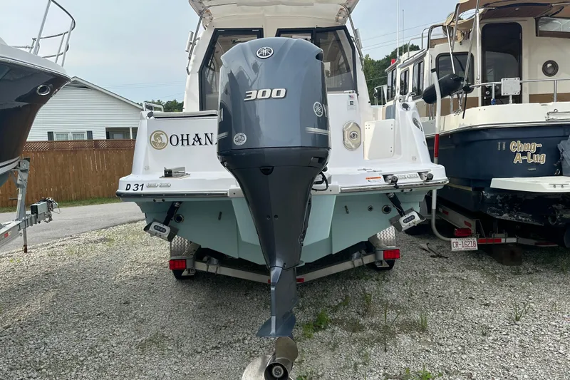 Slide: The Image of 2017 Cutwater C24 boat with Yamaha 300 outboard motor, parked on gravel. - 2