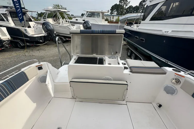 Slide: The Image of 2017 Cutwater C24 boat with outdoor kitchen and seating area in a marina. - 5