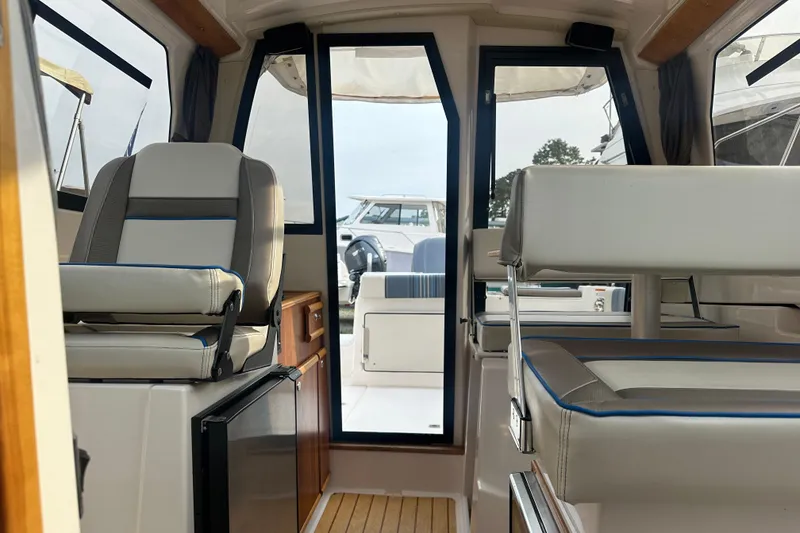 Slide: The Image of Interior of 2017 Cutwater C24 boat, featuring seating and cabinetry. - 6