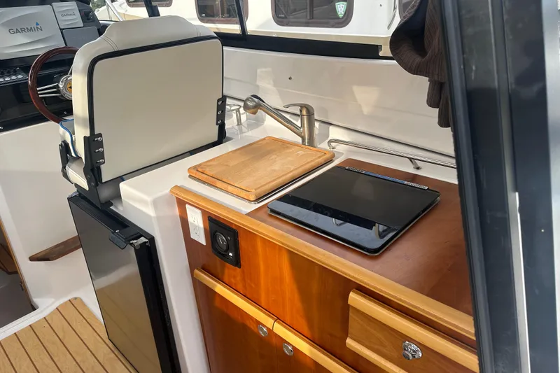 Slide: The Image of Interior of 2017 Cutwater C24 boat with kitchenette and navigation equipment. - 8