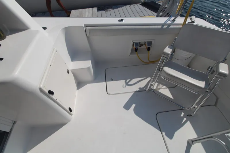 Slide: The Image of 1996 Silverton 41 Convertible boat deck with chair and utility connections. - 10