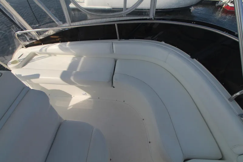 Slide: The Image of 1996 Silverton 41 Convertible yacht with white cushioned seating area. - 12