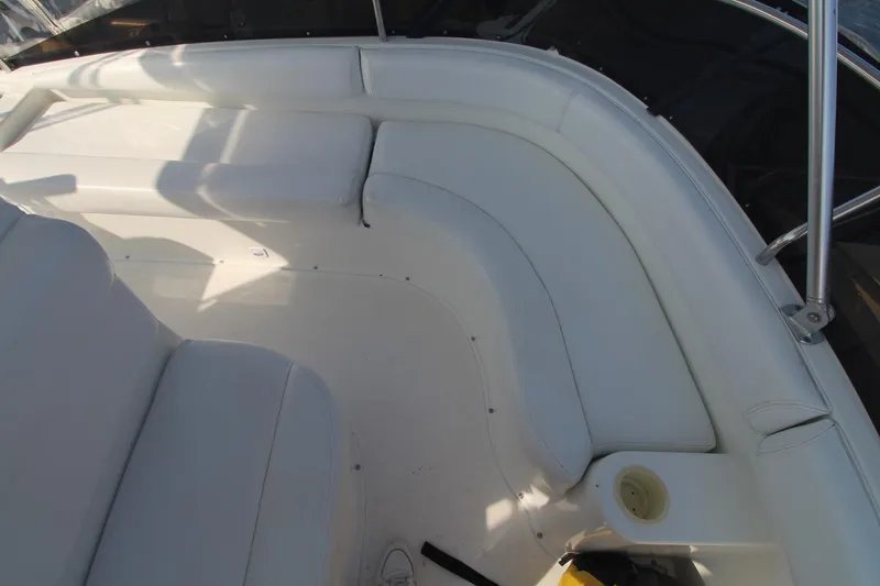 Slide: The Image of 1996 Silverton 41 Convertible boat interior with white seating and cup holder. - 13