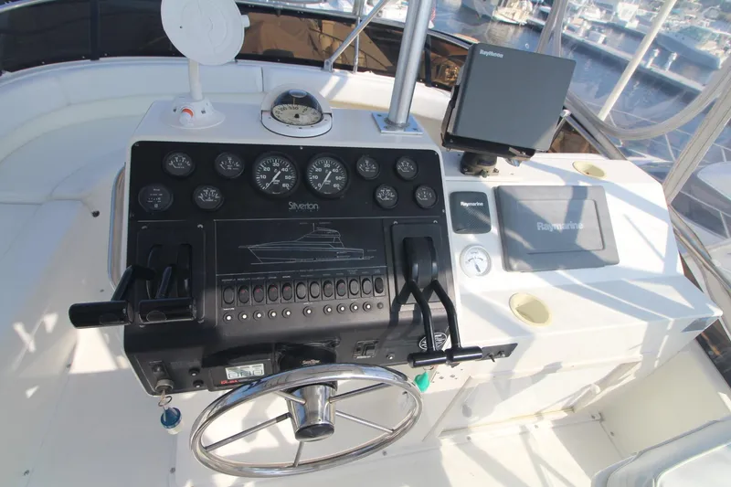 Slide: The Image of 1996 Silverton 41 Convertible yacht helm with navigation instruments and steering wheel. - 19