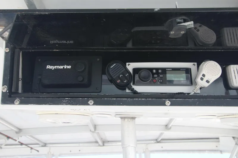 Slide: The Image of Marine electronics on a 1996 Silverton 41 Convertible, featuring Raymarine and Fusion devices. - 20