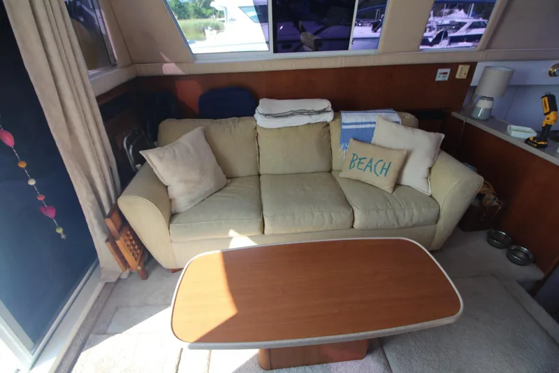Slide: The Image of Interior of 1996 Silverton 41 Convertible yacht with cozy sofa and table. - 23
