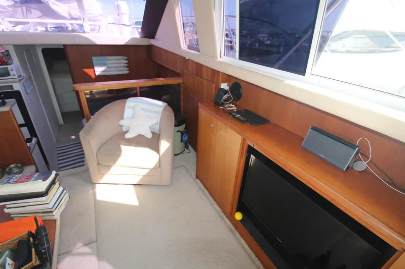 Slide: The Image of Interior of 1996 Silverton 41 Convertible yacht with cozy seating and modern amenities. - 28