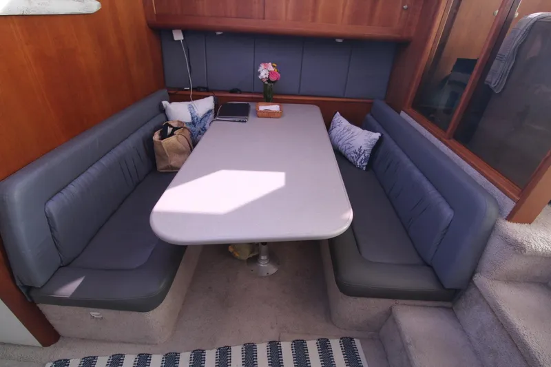 Slide: The Image of Interior of 1996 Silverton 41 Convertible yacht with cozy dining area. - 30