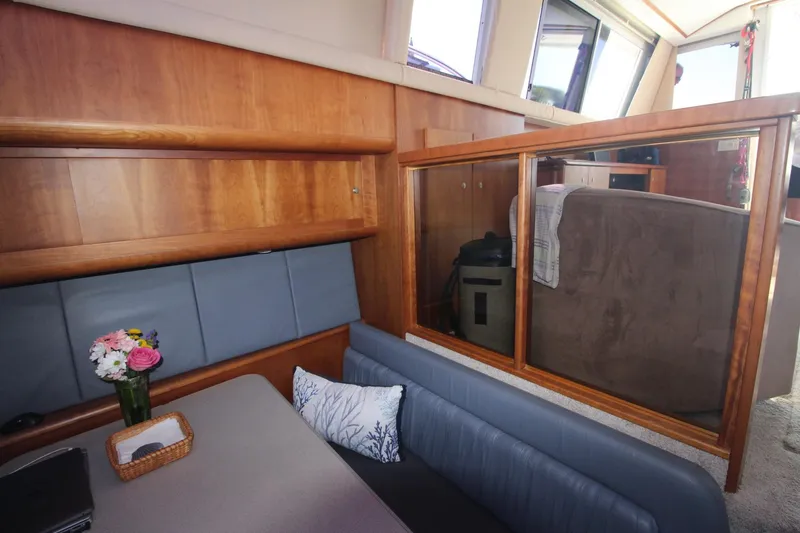 Slide: The Image of Interior of 1996 Silverton 41 Convertible yacht with wood paneling and seating area. - 31