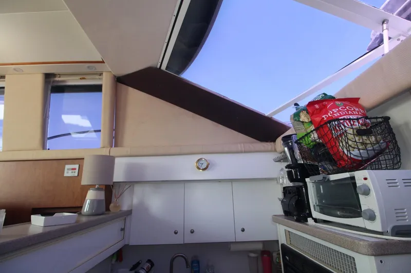 Slide: The Image of Interior of 1996 Silverton 41 Convertible yacht with kitchen appliances and snacks. - 32