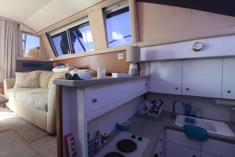 Slide: The Image of Interior of 1996 Silverton 41 Convertible yacht with cozy seating and compact kitchen. - 35