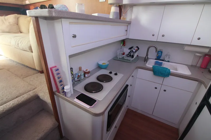 Slide: The Image of Compact kitchen in a 1996 Silverton 41 Convertible yacht with modern amenities. - 36