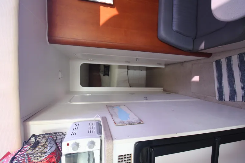 Slide: The Image of Interior of 1996 Silverton 41 Convertible yacht with modern amenities and cozy seating. - 37