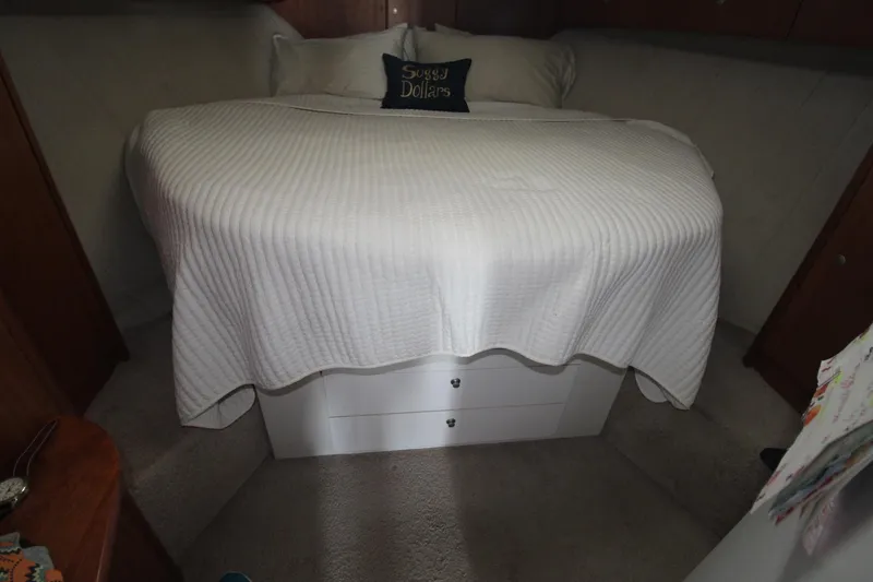 Slide: The Image of Cozy bedroom in 1996 Silverton 41 Convertible yacht with white bedding and decorative pillow. - 39