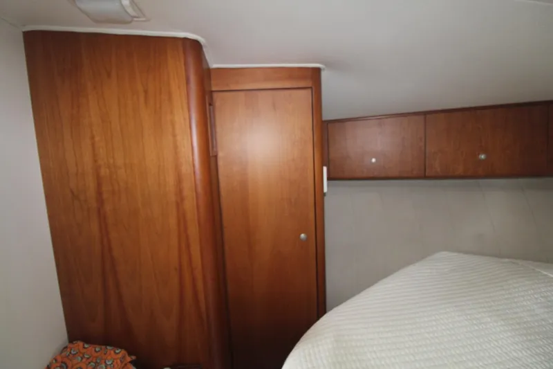 Slide: The Image of Interior of 1996 Silverton 41 Convertible with wooden cabinets and cozy bedding. - 40