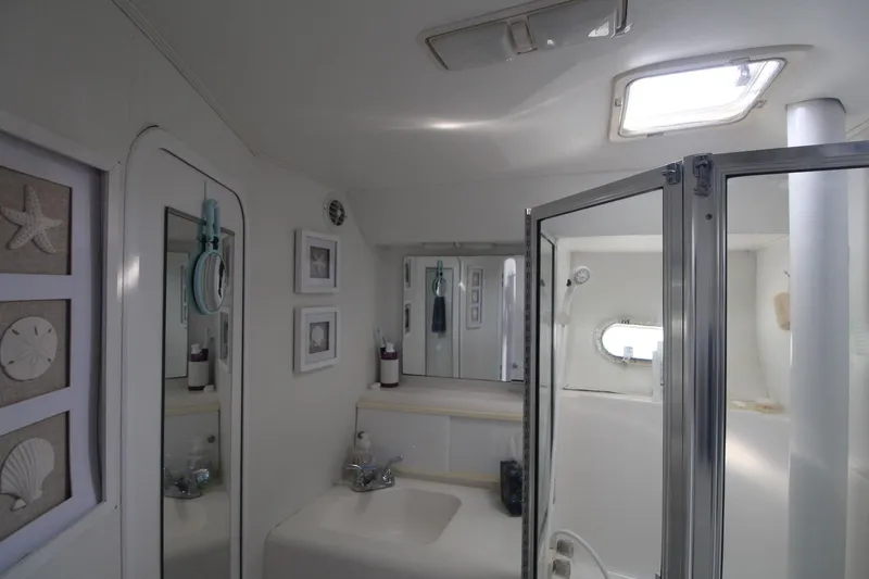 Slide: The Image of Bathroom interior of 1996 Silverton 41 Convertible yacht, featuring shower and nautical decor. - 41