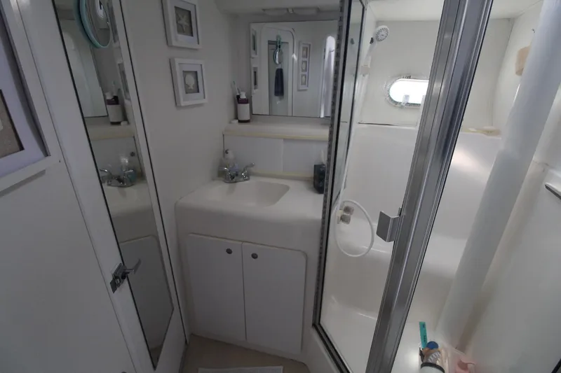 Slide: The Image of Bathroom interior of 1996 Silverton 41 Convertible yacht, featuring sink and shower. - 42