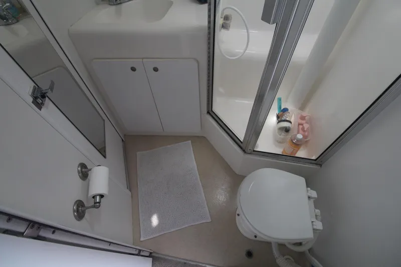 Slide: The Image of Bathroom interior of 1996 Silverton 41 Convertible yacht, featuring shower and toilet. - 43