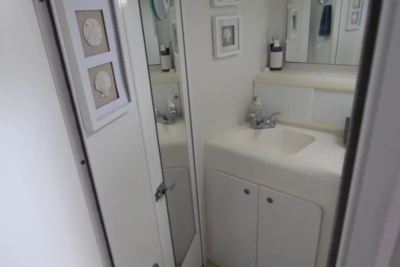 Slide: The Image of Bathroom interior of 1996 Silverton 41 Convertible yacht, featuring sink and nautical decor. - 45