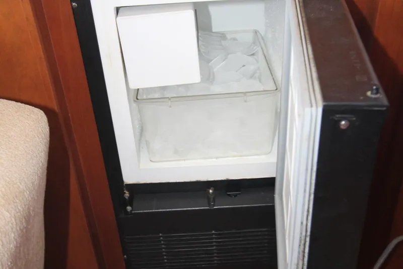 Slide: The Image of Ice maker inside a 1996 Silverton 41 Convertible boat, filled with ice cubes. - 47