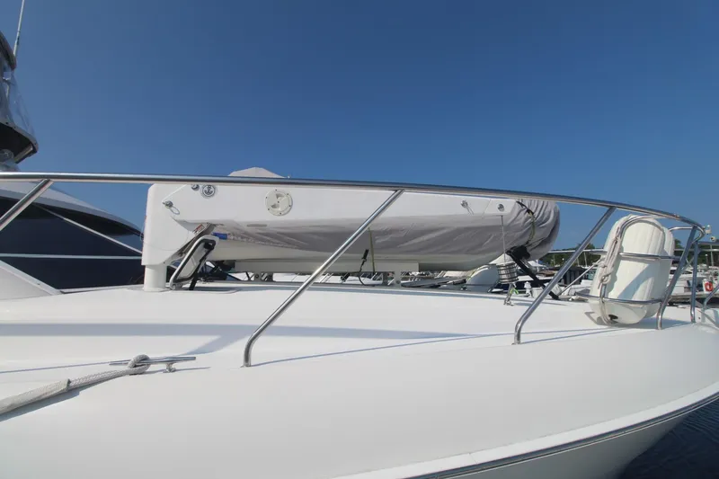 Slide: The Image of 1996 Silverton 41 Convertible yacht deck with railing and covered equipment. - 6