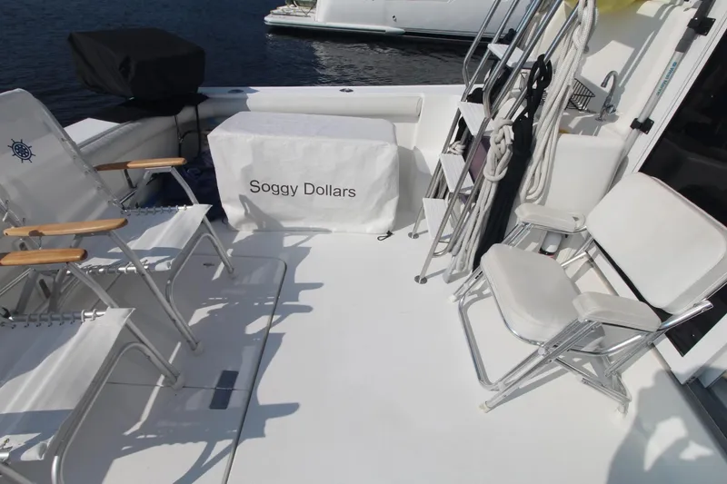 Slide: The Image of 1996 Silverton 41 Convertible yacht deck with chairs and "Soggy Dollars" cover. - 8