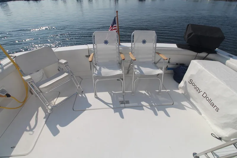 Slide: The Image of 1996 Silverton 41 Convertible boat deck with chairs and "Soggy Dollars" cover. - 9