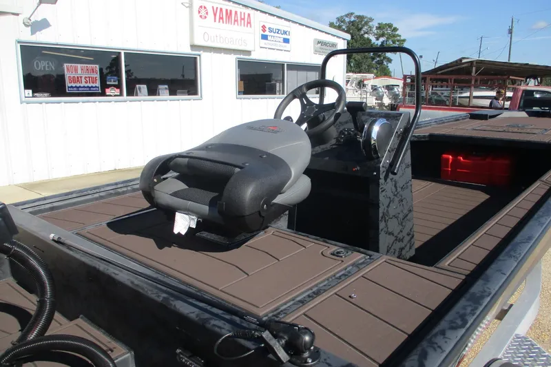 Slide: The Image of 2026 Gator Tail 2054 EXTREME CC boat interior with steering console and seating. - 7