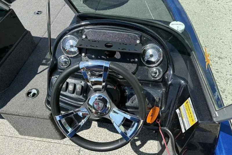 Slide: The Image of 2017 Triton 168 DV boat dashboard with chrome steering wheel and instrument panel. - 14