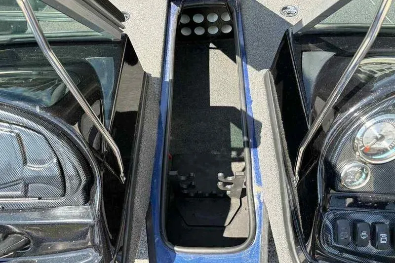 Slide: The Image of 2017 Triton 168 DV boat interior with storage compartment and dashboard controls. - 15