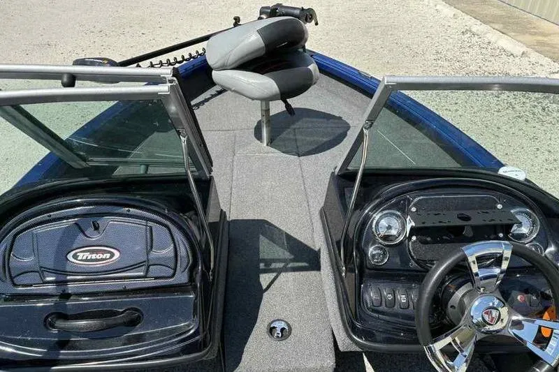 Slide: The Image of 2017 Triton 168 DV boat interior with steering wheel and seating. - 16