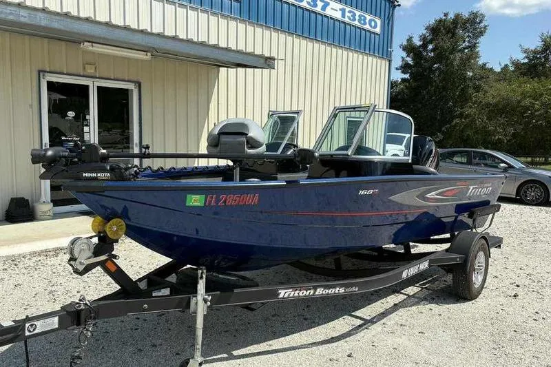 Slide: The Image of 2017 Triton 168 DV boat on trailer outside a building. - 3