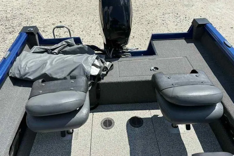 Slide: The Image of 2017 Triton 168 DV boat interior with two gray seats and motor. - 6
