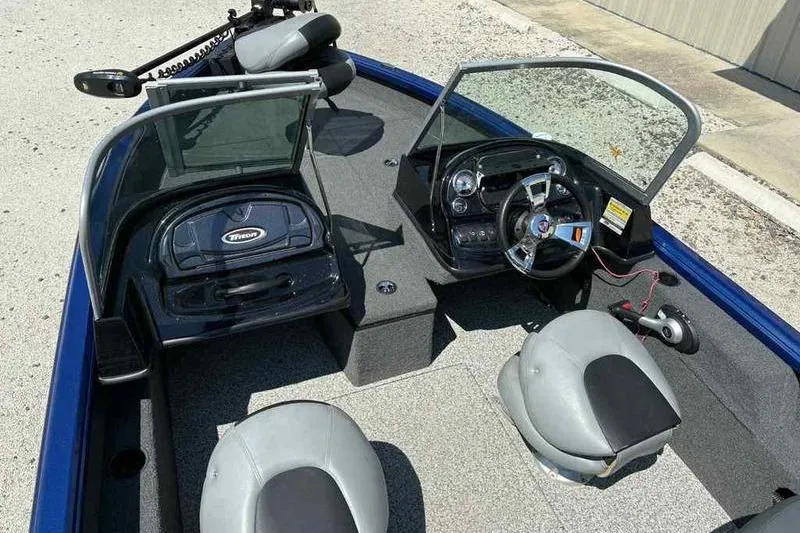 Slide: The Image of 2017 Triton 168 DV boat interior with dual seats and steering console. - 8