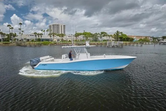 The Image of Invincible 36 boat cruising on water, 2015 model, with triple engines, scenic background. - 0