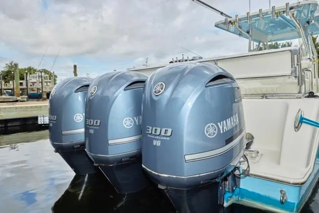 Slide: The Image of Invincible 36 boat cruising on water, 2015 model, with scenic coastal backdrop. - 1