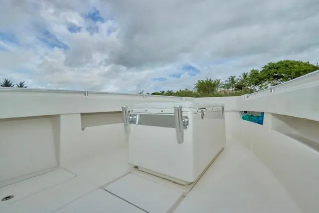 Slide: The Image of 2015 Invincible 36 boat deck with storage box under cloudy sky. - 13