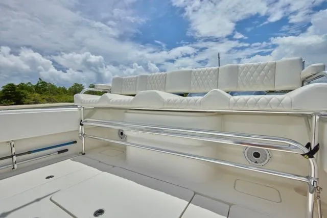 Slide: The Image of Invincible 36 boat, 2015 model, featuring white seating, cruising on a scenic waterway. - 15