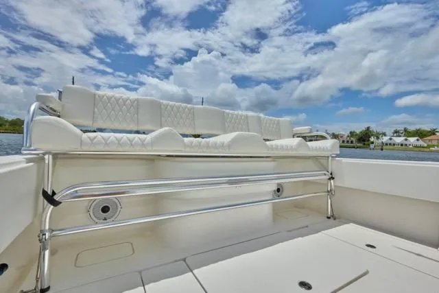 Slide: The Image of Luxurious seating on 2015 Invincible 36 boat under a partly cloudy sky. - 16