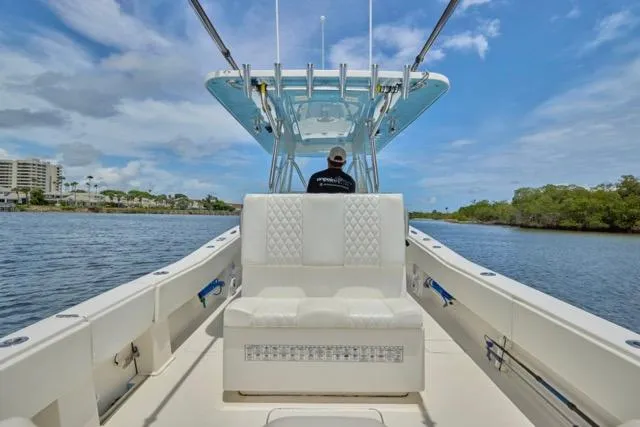 Slide: The Image of 2015 Invincible 36 boat deck with open side door, under a clear blue sky. - 18