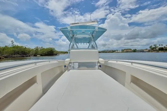 Slide: The Image of Invincible 36 boat, 2015 model, cruising on a sunny day with coastal view. - 23