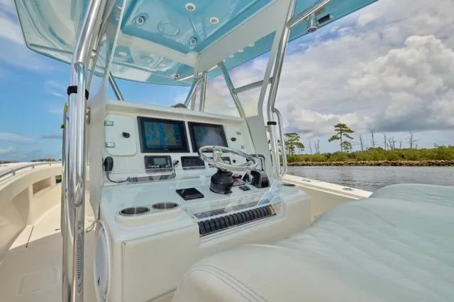 Slide: The Image of Invincible 36 boat, 2015 model, featuring white cushioned seating on a sunny day. - 32