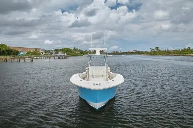 Slide: The Image of 2015 Invincible 36 boat docked with Yamaha engines, under a cloudy sky. - 35