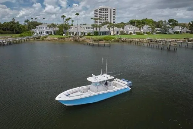 Slide: The Image of Aerial view of 2015 Invincible 36 boat with triple engines on water. - 46